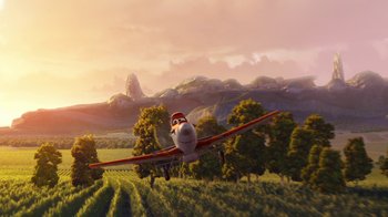 Movie still from “Planes” (2013), directed by Klay Hall – An airplane is flying over a field of grass; Extreme Wide shot, Low angle