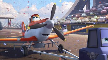 Movie still from “Planes” (2013), directed by Klay Hall – An airplane is parked in a parking lot with confetti; Wide shot, Low angle