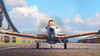 Movie still from “Planes” (2013), directed by Klay Hall – An airplane is parked on the ground with confetti flying around it; Wide shot, Low angle