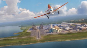 Movie still from “Planes” (2013), directed by Klay Hall – An airplane is flying over an industrial area; Extreme Wide shot, Low angle