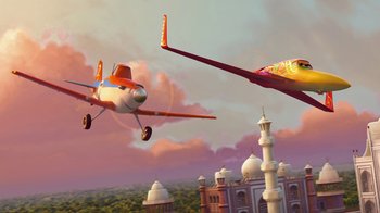 Movie still from “Planes” (2013), directed by Klay Hall – Two planes flying in the air near a building; Extreme Wide shot, Low angle