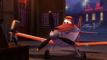 Movie still from “Planes” (2013), directed by Klay Hall – An orange and white airplane with a propeller; Wide shot, Low angle