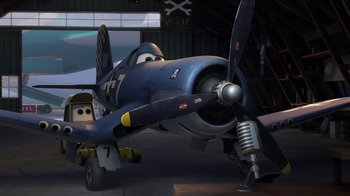 Movie still from “Planes” (2013), directed by Klay Hall – An airplane is parked inside of a hangar; Wide shot, Low angle