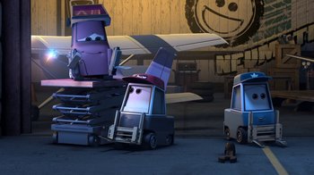 Movie still from “Planes” (2013), directed by Klay Hall – A group of toy cars sitting next to each other in front of an airplane; Wide shot, Low angle