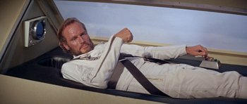 Movie still from “Planet of the Apes” (1968), directed by Franklin J. Schaffner – A man wearing a white shirt and a black tie; Medium shot, High angle