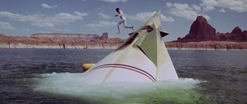 Movie still from “Planet of the Apes” (1968), directed by Franklin J. Schaffner – A man jumping off a boat into the water; Extreme Wide shot, High angle