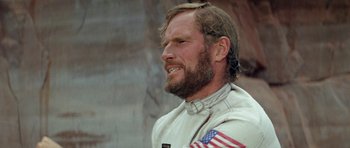 Movie still from “Planet of the Apes” (1968), directed by Franklin J. Schaffner – A person with a flag on his shirt; Close Up shot, Low angle