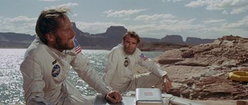 Movie still from “Planet of the Apes” (1968), directed by Franklin J. Schaffner – A man sitting on the back of a sailboat in the water; Medium shot, Low angle