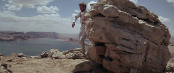 Movie still from “Planet of the Apes” (1968), directed by Franklin J. Schaffner – A man climbing a rock formation on top of a mountain; Wide shot, Low angle