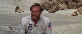 Movie still from “Planet of the Apes” (1968), directed by Franklin J. Schaffner – A man in a spacesuit is smiling for the camera; Close Up shot, Over the shoulder angle