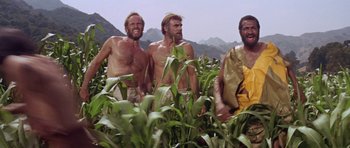 Movie still from “Planet of the Apes” (1968), directed by Franklin J. Schaffner – A group of men standing next to each other in a field; Wide shot, Low angle