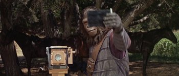 Movie still from “Planet of the Apes” (1968), directed by Franklin J. Schaffner – A man taking a picture with a cell phone; Medium shot, Low angle