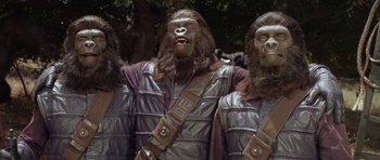 Movie still from “Planet of the Apes” (1968), directed by Franklin J. Schaffner – A group of people dressed like apes standing next to each other; Medium shot, Low angle