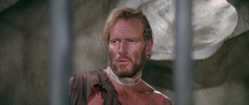 Movie still from “Planet of the Apes” (1968), directed by Franklin J. Schaffner – A man with a beard and a neck tie; Close Up shot, Low angle