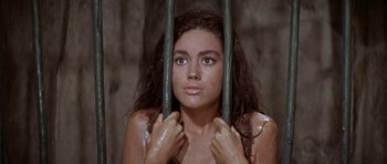 Movie still from “Planet of the Apes” (1968), directed by Franklin J. Schaffner – A young woman holding onto a metal bar; Close Up shot, High angle