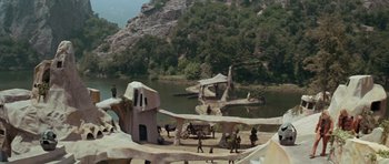 Movie still from “Planet of the Apes” (1968), directed by Franklin J. Schaffner – A group of people standing on top of a hill next to a lake; Extreme Wide shot, High angle