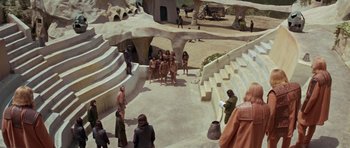 Movie still from “Planet of the Apes” (1968), directed by Franklin J. Schaffner – A group of people standing around in an open area; Extreme Wide shot, High angle