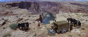 Movie still from “Planet of the Apes” (1968), directed by Franklin J. Schaffner – A man standing next to a horse drawn carriage on top of a mountain; Extreme Wide shot, High angle
