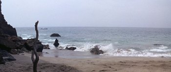 Movie still from “Planet of the Apes” (1968), directed by Franklin J. Schaffner – A person riding a horse on the beach near the ocean; Extreme Wide shot, High angle