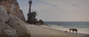 Movie still from “Planet of the Apes” (1968), directed by Franklin J. Schaffner – A statue of liberty sitting on top of a beach next to the ocean; Extreme Wide shot, Low angle