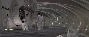 Movie still from “Planet of the Apes” (2001), directed by Tim Burton – A group of people standing around in a room; Extreme Wide shot, High angle