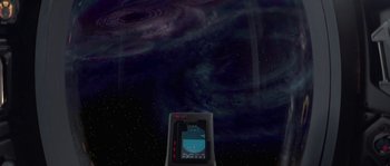 Movie still from “Planet of the Apes” (2001), directed by Tim Burton – A cell phone is shown in front of a nebula; Extreme Wide shot, Overhead angle