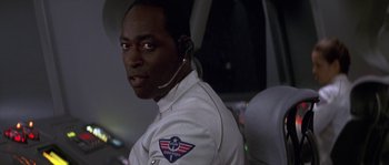 Movie still from “Planet of the Apes” (2001), directed by Tim Burton – A man in a white uniform with a headset on; Close Up shot, Over the shoulder angle