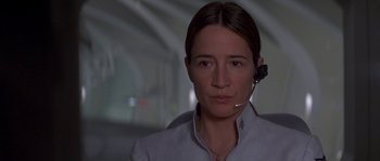 Movie still from “Planet of the Apes” (2001), directed by Tim Burton – A woman wearing a headset in a dark room; Close Up shot, Low angle