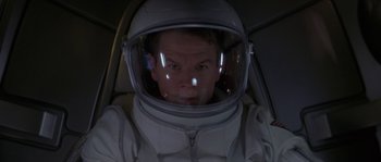 Movie still from “Planet of the Apes” (2001), directed by Tim Burton – A man in a spacesuit with a helmet on; Close Up shot, Overhead angle