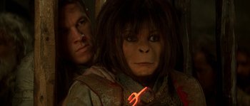 Movie still from “Planet of the Apes” (2001), directed by Tim Burton – A man standing next to a woman with a light in her mouth; Close Up shot, High angle