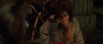 Movie still from “Planet of the Apes” (2001), directed by Tim Burton – A person with long hair and a monkey mask; Close Up shot, High angle