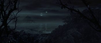 Movie still from “Planet of the Apes” (2001), directed by Tim Burton – A night scene of the ocean with two green lights in the sky; Extreme Wide shot, High angle