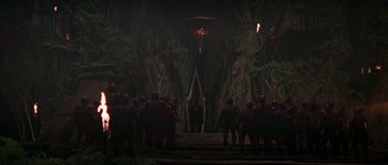 Movie still from “Planet of the Apes” (2001), directed by Tim Burton – A group of people standing in front of trees; Extreme Wide shot, High angle