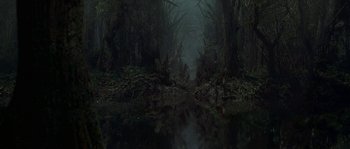 Movie still from “Planet of the Apes” (2001), directed by Tim Burton – A forest with a body of water in the foreground; Extreme Wide shot, High angle
