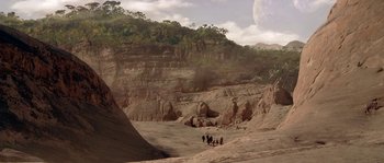 Movie still from “Planet of the Apes” (2001), directed by Tim Burton – A group of people are walking through the desert; Extreme Wide shot, High angle