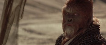 Movie still from “Planet of the Apes” (2001), directed by Tim Burton – A person wearing a gorilla mask; Close Up shot, Over the shoulder angle