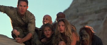 Movie still from “Planet of the Apes” (2001), directed by Tim Burton – A group of people standing next to each other; Medium shot, Low angle