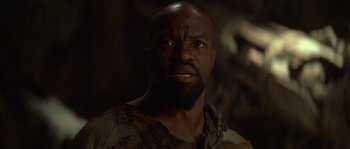 Movie still from “Planet of the Apes” (2001), directed by Tim Burton – A man with a beard is looking at the camera; Close Up shot, Low angle