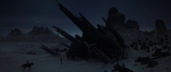 Movie still from “Planet of the Apes” (2001), directed by Tim Burton – A group of people standing around a large structure; Extreme Wide shot, Low angle