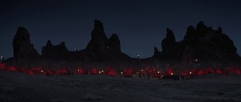 Movie still from “Planet of the Apes” (2001), directed by Tim Burton – A group of people camping in the desert at night; Extreme Wide shot, High angle