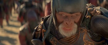 Movie still from “Planet of the Apes” (2001), directed by Tim Burton – A person wearing a helmet and holding a sword; Close Up shot, Low angle