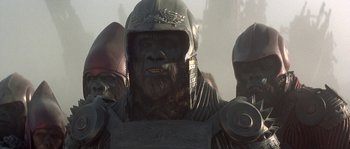 Movie still from “Planet of the Apes” (2001), directed by Tim Burton – A group of people in costumes standing next to each other; Close Up shot, Low angle