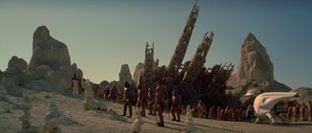 Movie still from “Planet of the Apes” (2001), directed by Tim Burton – A group of people standing next to each other on a beach; Extreme Wide shot, Low angle