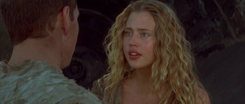 Movie still from “Planet of the Apes” (2001), directed by Tim Burton – A woman with long blonde curly hair looking at a man; Close Up shot, Over the shoulder angle