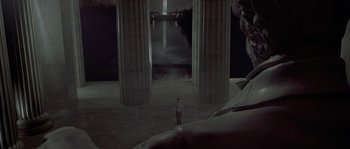 Movie still from “Planet of the Apes” (2001), directed by Tim Burton – A man standing in front of a statue in a large room; Extreme Wide shot, High angle