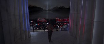 Movie still from “Planet of the Apes” (2001), directed by Tim Burton – A man standing in front of a bunch of parked cars; Extreme Wide shot, High angle