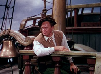 Movie still from “Plymouth Adventure” (1952), directed by Clarence Brown – A man sitting on top of a wooden railing on top of a boat; Medium shot, Low angle