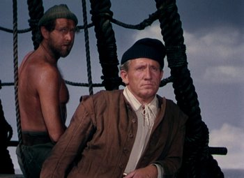 Movie still from “Plymouth Adventure” (1952), directed by Clarence Brown – A man sitting next to another man on a boat; Medium shot, Low angle