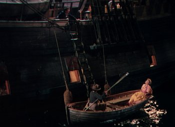 Movie still from “Plymouth Adventure” (1952), directed by Clarence Brown – Two people in a boat in the middle of the ocean; Extreme Wide shot, High angle