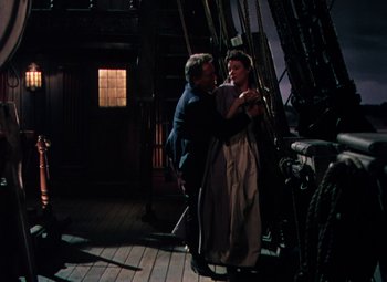 Movie still from “Plymouth Adventure” (1952), directed by Clarence Brown – A man and a woman are standing on a boat; Wide shot, High angle